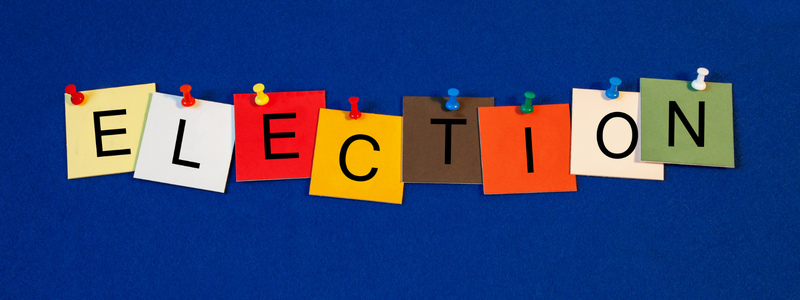 The word election displayed as post it notes on a piece of string against a blue background